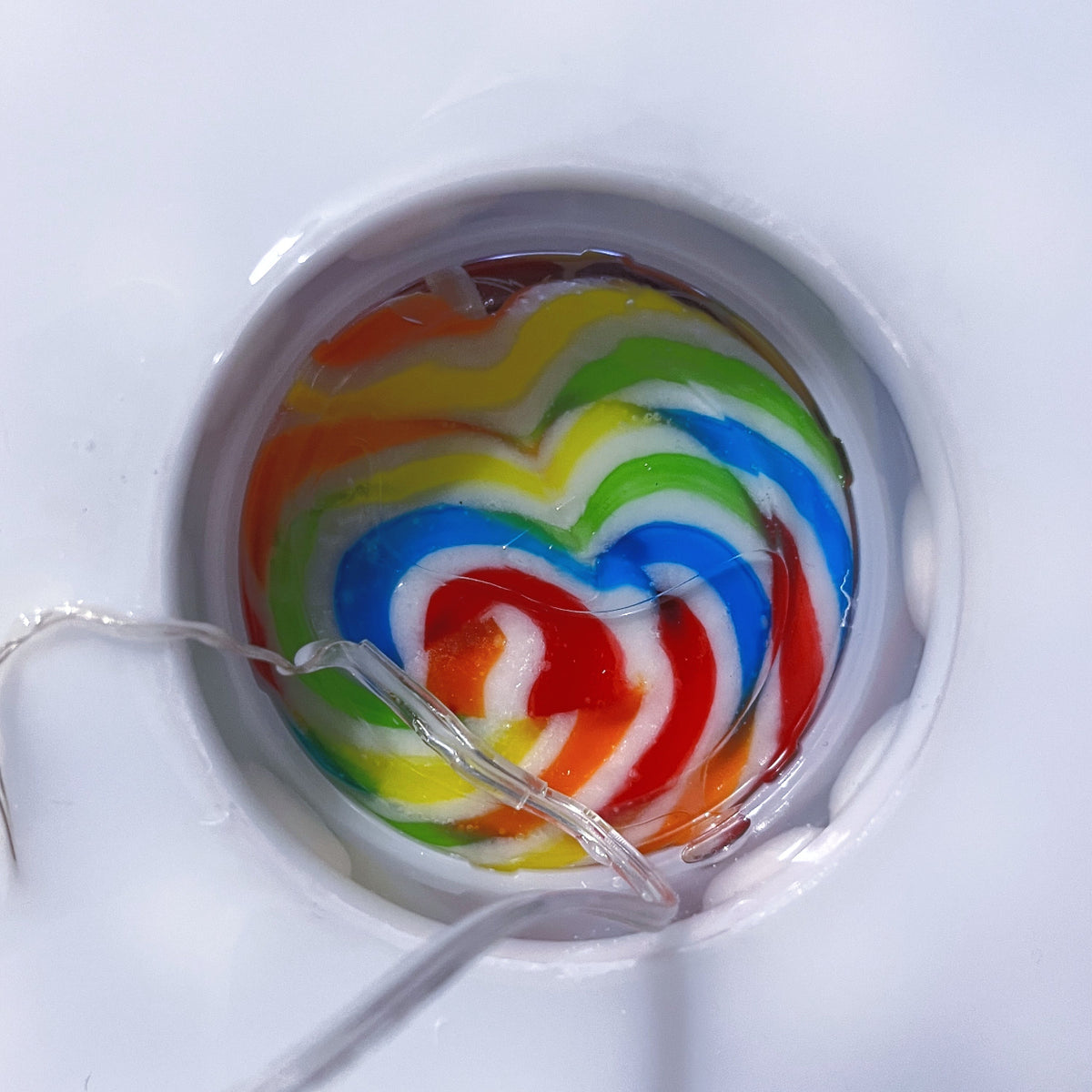 Colorful lollipop with a heart shape on a white background