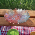 Sunflower Fruit Bowl - Decorative resin bowl shaped like a sunflower on a wooden surface with a checkered tablecloth in the background.