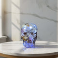 Decorative Pebble Led Skull, embedded with LED lights on a round marble table