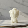 Male Torso Figurine, handmade resin ornament showcasing minimalist design and contemporary artistry on a marble table.