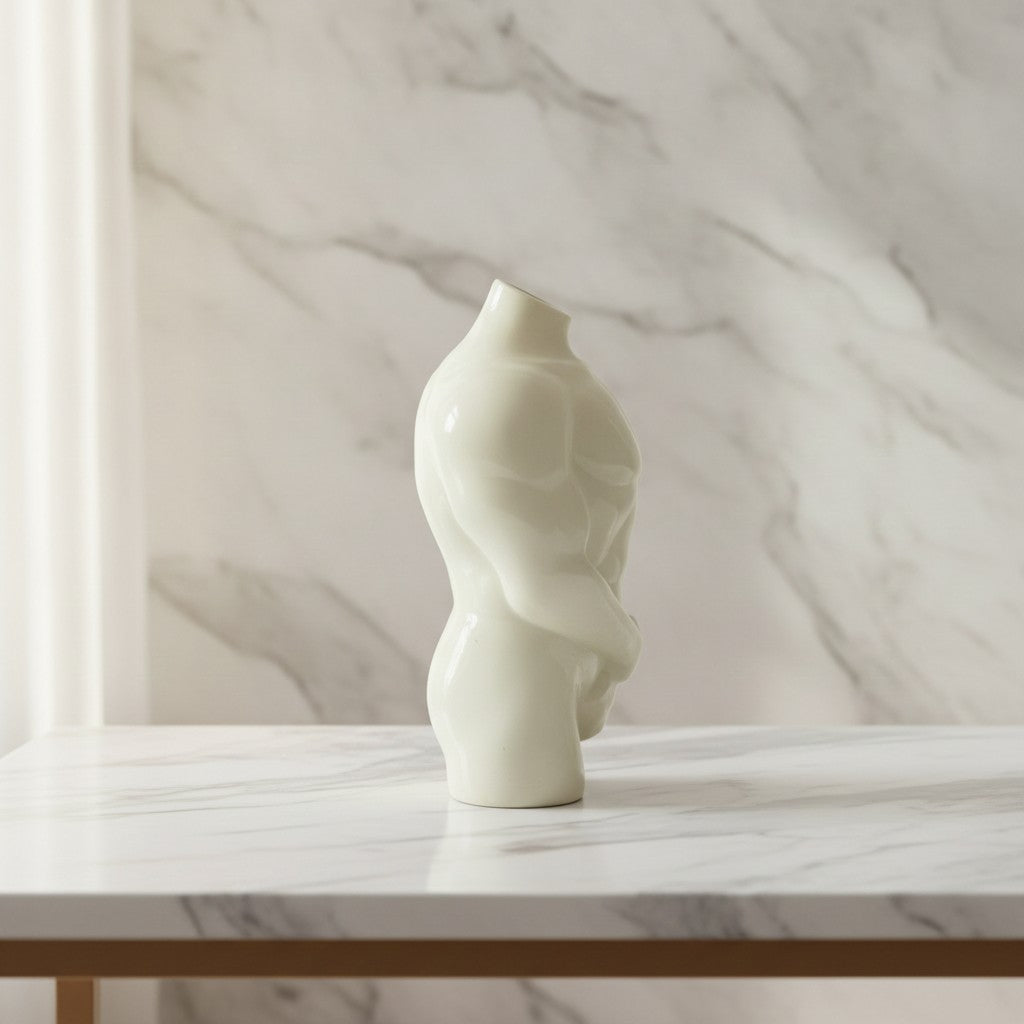 Male Torso Figurine displayed on a marble table, showcasing its minimalist design and handcrafted resin finish.