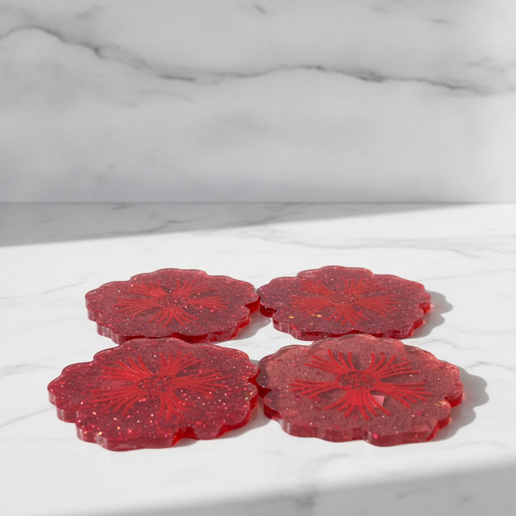 Flower shaped coasters - Four red glitter flower-shaped coasters arranged in a 2x2 grid on a white marble surface with a matching marble background.