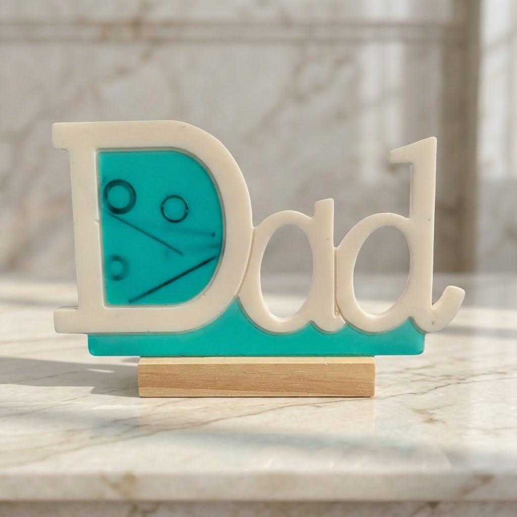 Handmade Dad Plaque - A 3D wooden 'Dad' letter sign with a turquoise blue inner panel and a light wood base, displayed on a marble surface.